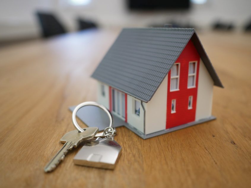 House key next to model of a house