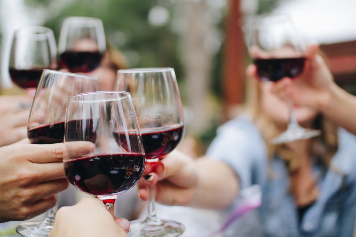 People toasting with wine glasses